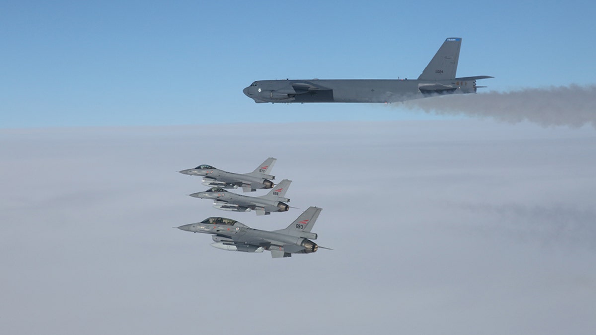 A U.S. B-52 Stratofortresses, deployed from Barksdale Air Force Base, La., flies in formation with three Norwegian F-16 Fighting Falcons over Norway, March 28, 2019. 