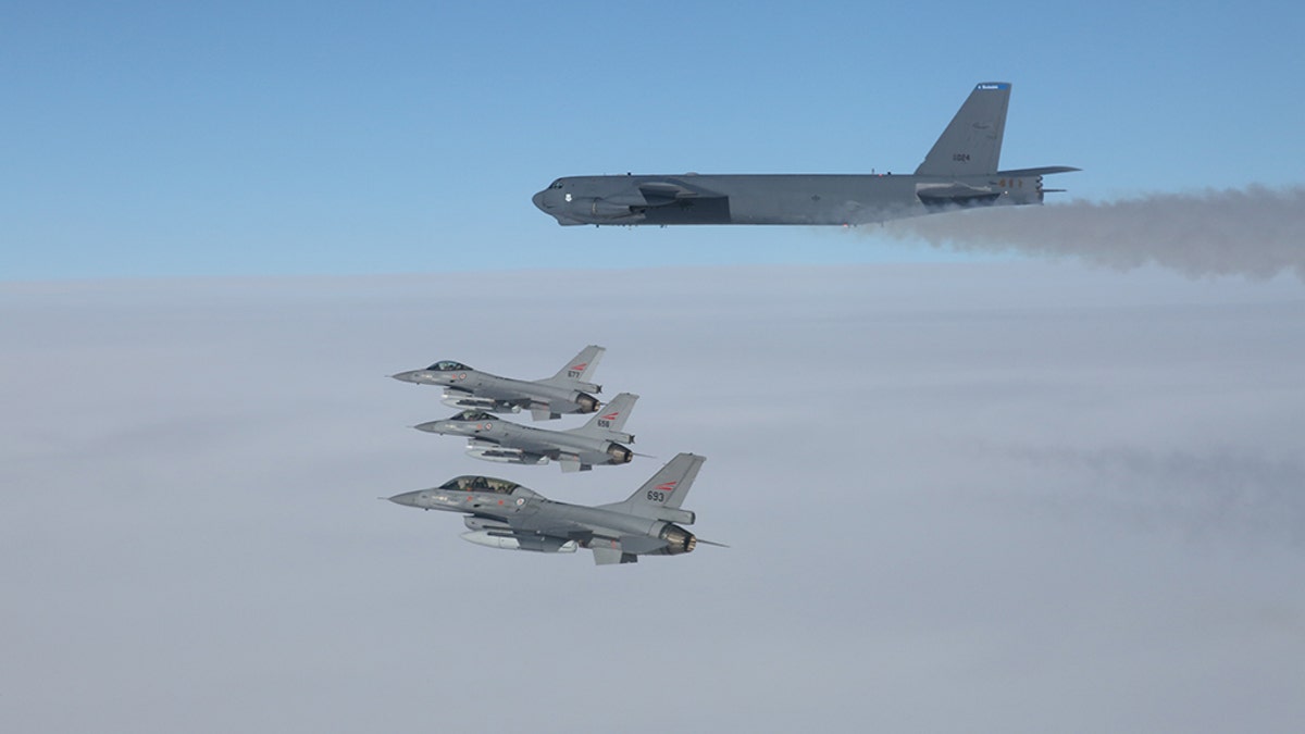 A U.S. B-52 Stratofortresses, deployed from Barksdale Air Force Base, La., flies in formation with three Norwegian F-16 Fighting Falcons over Norway, March 28, 2019.