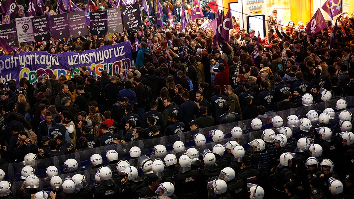 Turkish police block protesters wanting to hold a march for the International Women's Day, at Istiklal street, the main shopping street in Istanbul, Friday, March 8, 2019. The day has been sponsored by the United Nations since 1975 as millions around the world are demanding equality amid a persistent salary gap, violence and widespread inequality. (AP Photo/Lefteris Pitarakis)