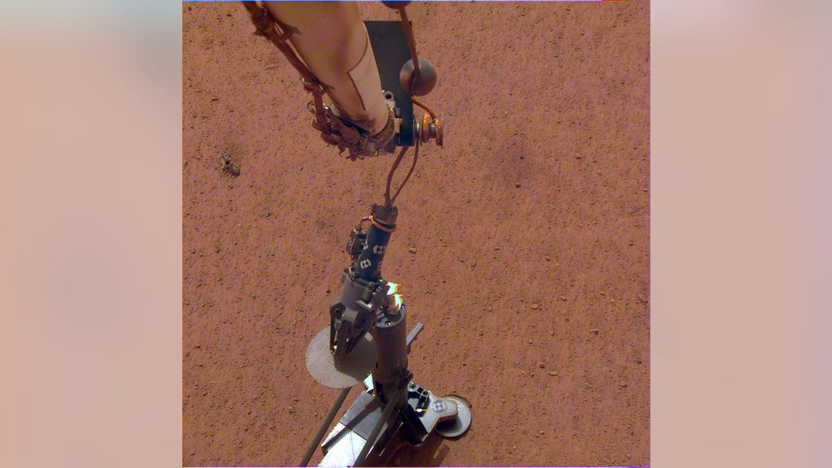 NASA's InSight lander deploys its heat probe on Mars on Feb. 12, 2019.