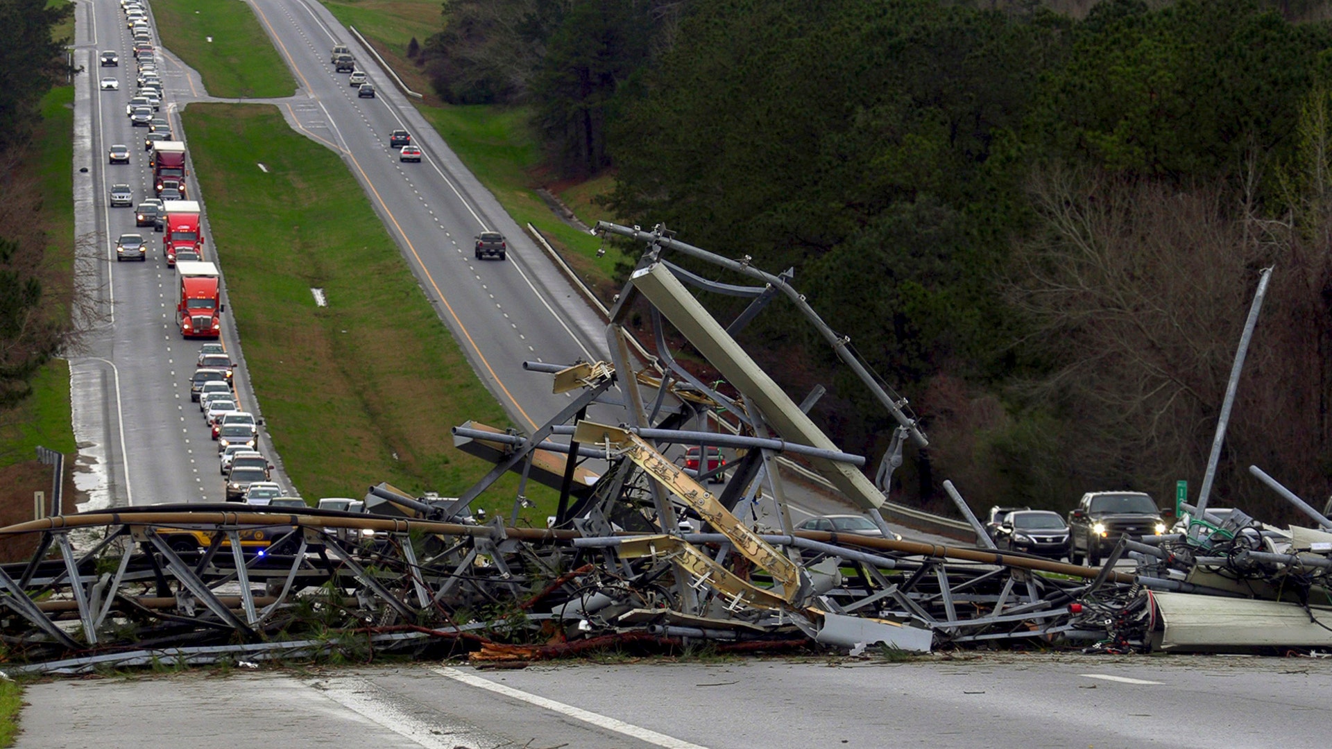 A fallen cell tower lies across U.S. Route 280 highway in Lee County, Ala., in the Smiths Station community after what appeared to be a tornado struck in the area March 3. Severe storms destroyed mobile homes, snapped trees and left a trail of destruction amid weather warnings extending into Georgia, Florida and South Carolina, authorities said. 