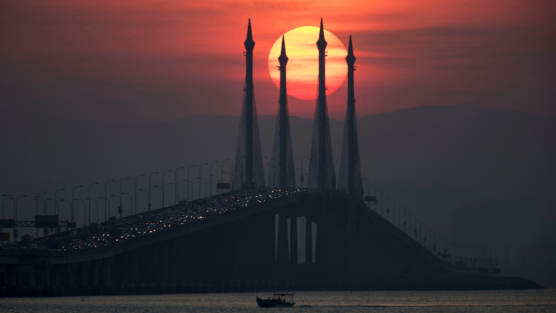 The sun rises over Penang Bridge in Penang Island, Northern Malaysia, March 7, 2019. 