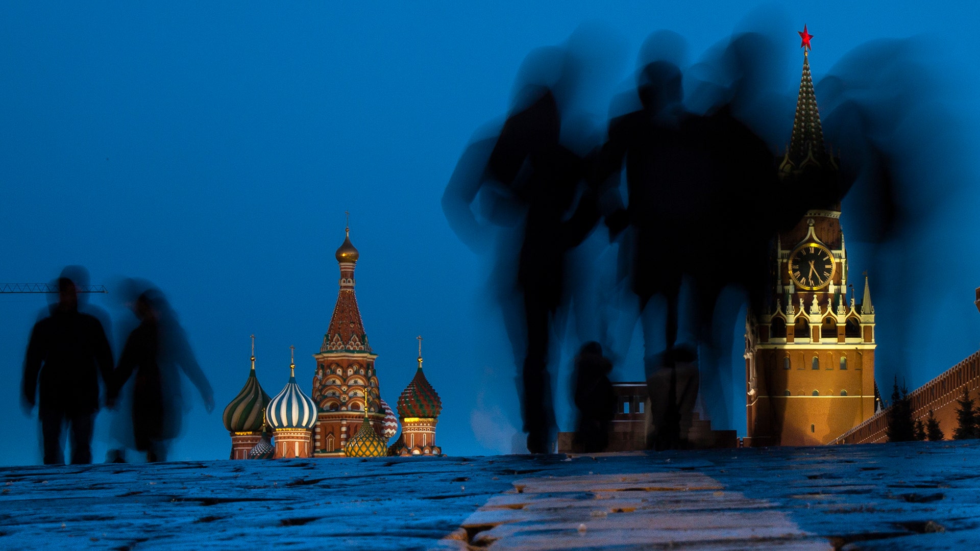 People walk through Red Square after sunset in Moscow, Russia, March 3, 2019.