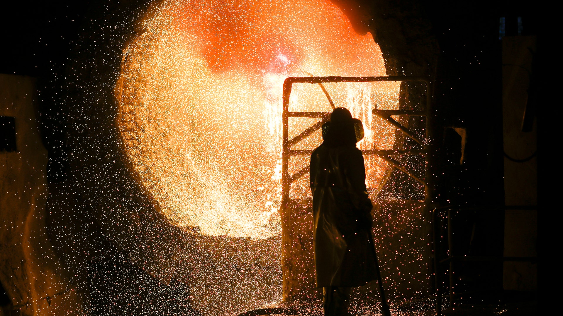 An employee in protective clothing maintains a steel pouring ladle at the steel producer Salzgitter AG in Salzgitter, Germany, March 5, 2019. 