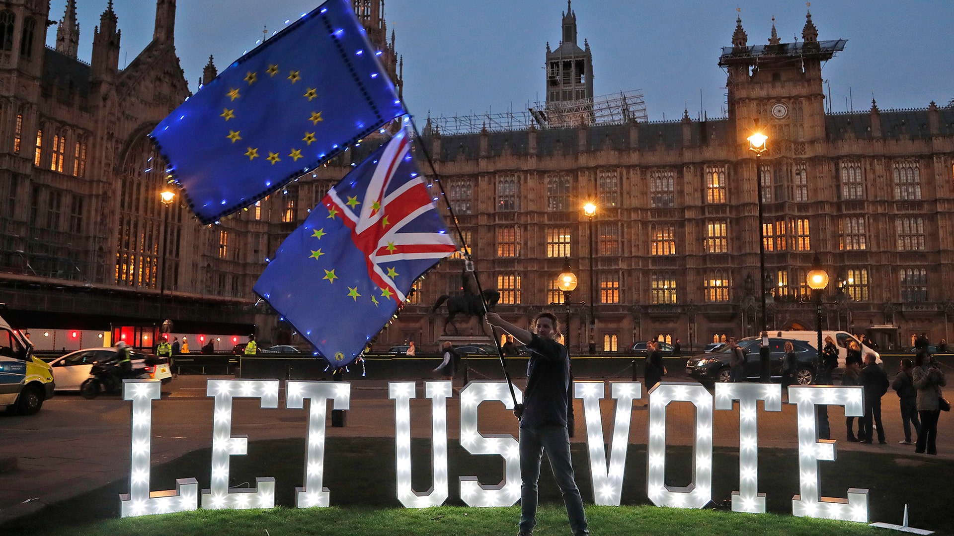 A sign reading "LET US VOTE" is set up outside Parliament by the public and civic organization Avaaz in London, March 27, 2019. 