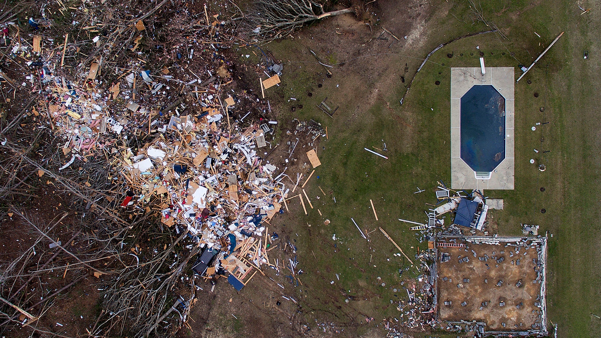 Debris from a home litters a yard the day after a tornado blew it off its foundation in Beauregard, Alabama, March 4, 2019.