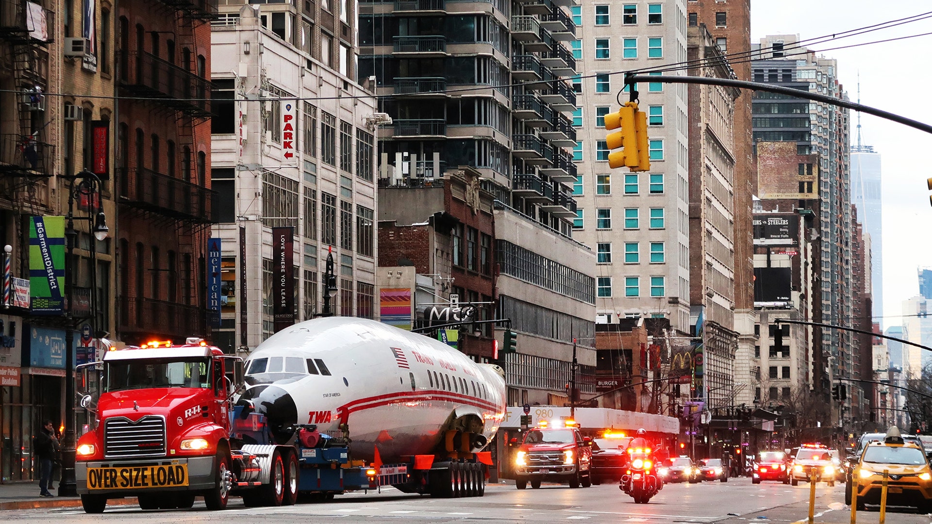 A vintage TWA Lockheed Constellation airplane is transported along 6th Avenue on its way to Times Square in New York City, March 23, 2019.