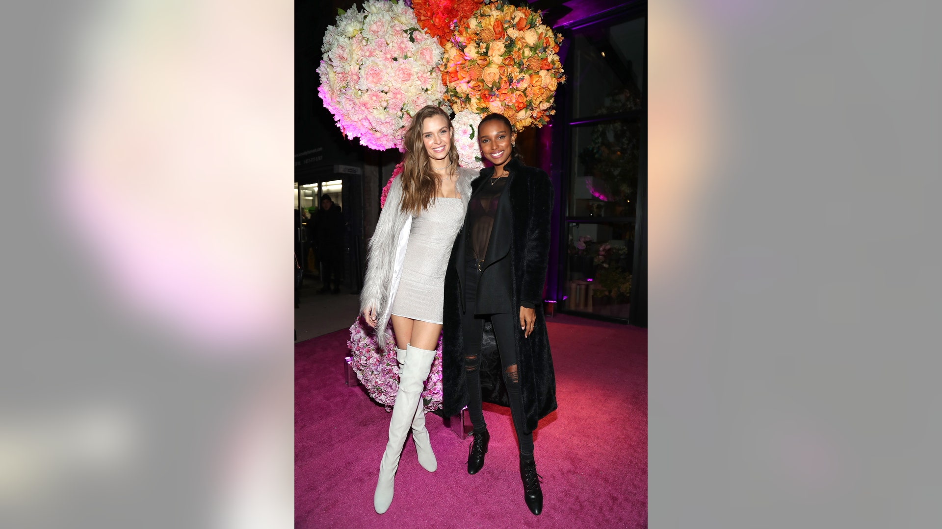 Victoria's Secret Angels Josephine Skriver and Jasmine Tookes pose on the pink carpet at the Feroce And The Fleur Room Grand Opening at the Moxy Hotel - Chelsea on March 7, 2019 in New York City. 