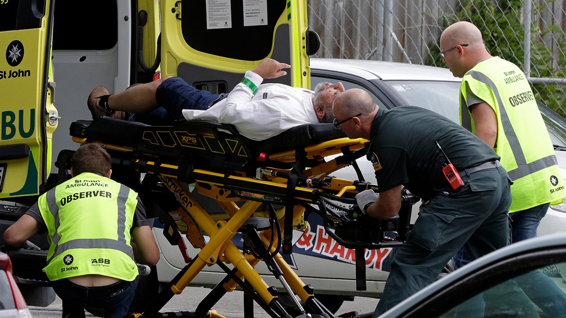 Medics load a wounded man into an ambulance following the deadly attack. (AP Photo/Mark Baker)