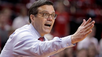 Nebraska Cornhuskers coach Tim Miles takes tumble on way to locker room after win