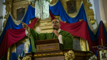 Priest under siege in battle over Venezuela's political soul