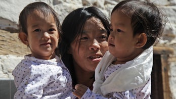 Conjoined twins back in Bhutan after separation in Australia