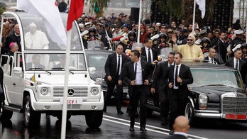 Man rushes car carrying Moroccan king during motorcade with Pope Francis