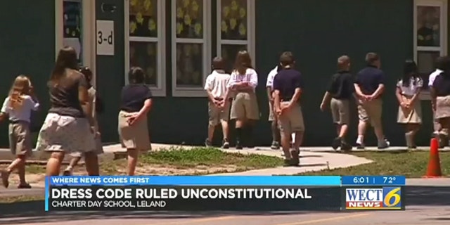Students play outside Charter Day. The school's dress code was deemed unconstitutional
