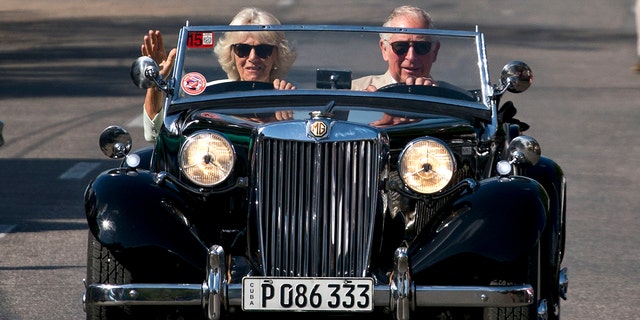 Prince Charles drives a vintage car with his wife Camilla, Duchess of Cornwall, during a cultural event in Havana, Cuba, March 26, 2019. 