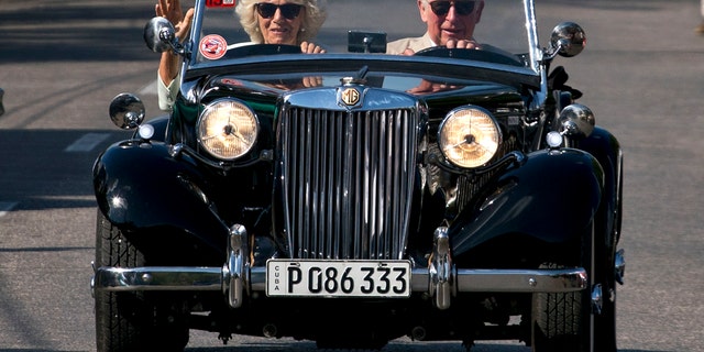 Prince Charles drives a vintage car with his wife Camilla, Duchess of Cornwall, during a cultural event in Havana, Cuba, March 26, 2019.
