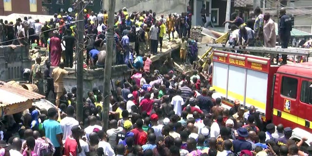 Rescue workers and emergency teams at the scene of the building collapse in Lagos, Nigeria.