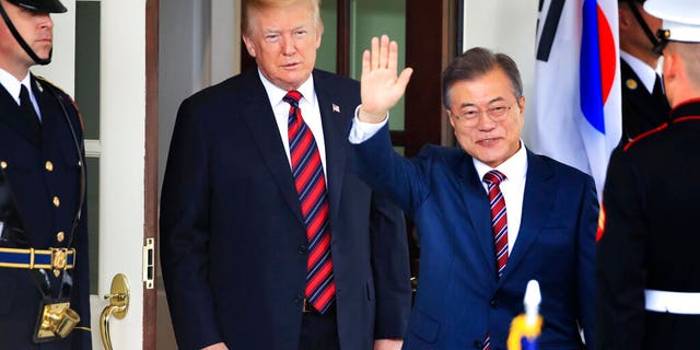 FILE: South Korean President Moon Jae-in waves as he is welcomed by U.S. President Donald Trump to the White House in Washington on May 22, 2018.