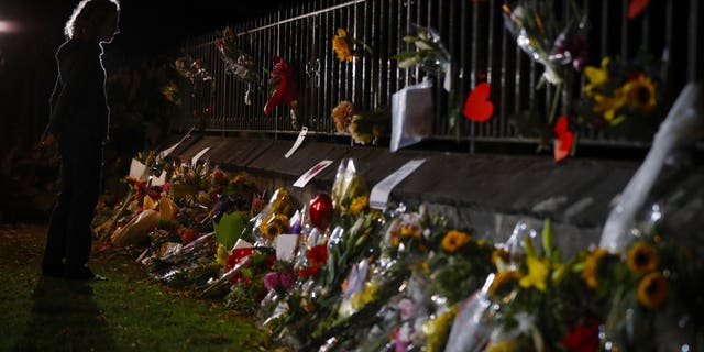 Mourners pay their respects at a makeshift memorial near the Masjid Al Noor mosque in Christchurch, New Zealand, Saturday, March 16, 2019. New Zealand's stricken residents reached out to Muslims in their neighborhoods and around the country on Saturday, in a fierce determination to show kindness to a community in pain as a 28-year-old white supremacist stood silently before a judge, accused in mass shootings at two mosques that left dozens of people dead.