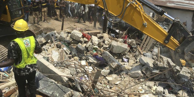Emergency services at the scene after a school building collapsed in Lagos, Nigeria, on Wednesday.