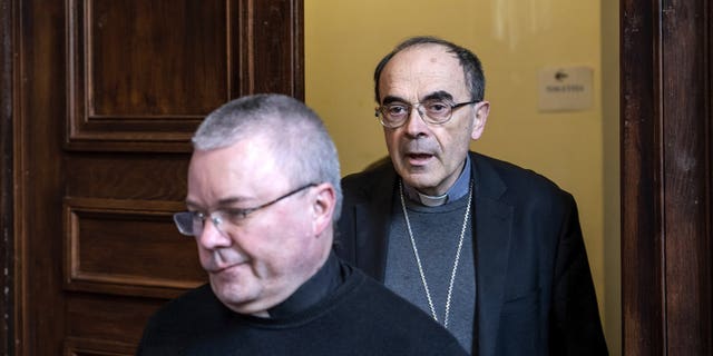 French Cardinal Philippe Barbarin, right, arrives for a press conference in Lyon, central France, Thursday, March 7, 2019. Barbarin offers his resignation to the Pope after a court on Thursday found him guilty of failing to report to authorities allegations of sexual abuse of minors by a priest.
