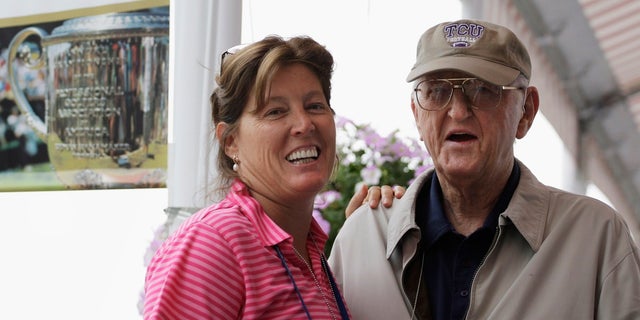FILE - In this Aug. 15, 2009, file photo, sports writer Dan Jenkins, right, stands next to his daughter, Sally Jenkins, at the PGA Championship at Hazeltine National Golf Club in Chaska, Minn. Jenkins, the sports writing great and best-selling author known for his humor, has died. He was 90. (AP Photo/Jeff Roberson, File)