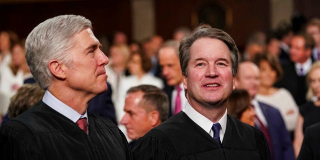 In this Feb. 5, 2019, file photo, Supreme Court Associate Justices Neil Gorsuch, left, and Brett Kavanaugh watch as President Donald Trump arrives to give his State of the Union address. Trump has an opportunity to add a third justice to the Supreme Court after the death of late Justice Ruth Bader Ginsburg. (Doug Mills/The New York Times via AP, Pool)