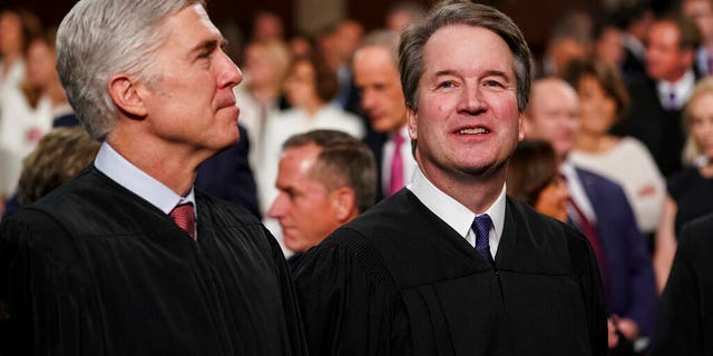 In this Feb. 5, 2019 file photo, Supreme Court Associate Justices Neil Gorsuch, left, and Brett Kavanaugh watch as President Donald Trump arrives to give his State of the Union address to a joint session on Congress at the Capitol in Washington, D.C. (Doug Mills/The New York Times via AP, Pool)