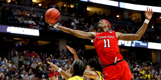 Texas Tech forward Tariq Owens (11) shoots over Michigan defenders during the second half an NCAA men's college basketball tournament West Region semifinal. (Associated Press)