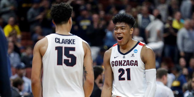 Gonzaga forward Rui Hachimura, right, and forward Brandon Clarke celebrate the team's win against Florida State during an NCAA men's college basketball tournament West Region semifinal. (Associated Press)