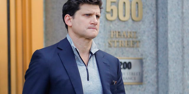 Gordon Caplan of Greenwich, Conn., walks out of federal court Tuesday in New York.