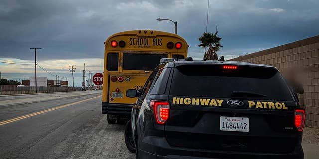 Officials stopped the vehicle after it passed by a school bus with its flashing lights and posted stop sign.
