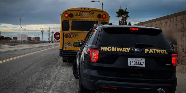 Officials stopped the vehicle after it passed by a school bus with its flashing lights and posted stop sign.