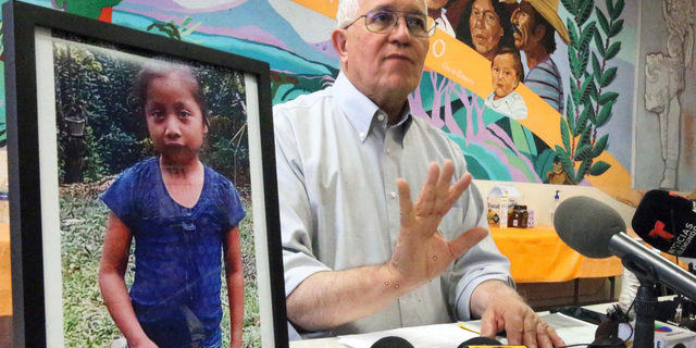 FILE - In this Dec. 15, 2018, file photo, Annunciation House director Ruben Garcia answers questions from the media after reading a statement from the family of Jakelin Caal Maquin, pictured at left, during a press briefing at Casa Vides in downtown El Paso, Texas. An autopsy has found that the 7-year-old girl from Guatemala who was detained by the U.S. Border Patrol died of a bacterial infection. Jakelin died on Dec. 8, just over a day after she was apprehended by Border Patrol agents with her father. (Rudy Gutierrez/The El Paso Times via AP, File)