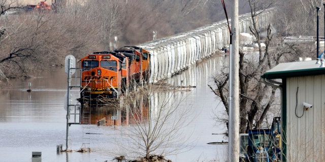 A BNSF train sits in flood waters from the Platte River, in Plattsmouth, Neb., Sunday, March 17, 2019. (AP Photo/Nati Harnik)