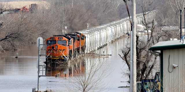 A BNSF sight sits in inundate waters from a Platte River, in Plattsmouth, Neb., Sunday, Mar 17, 2019. (AP Photo/Nati Harnik)