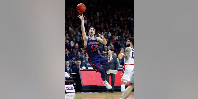 St. Mary's Tommy Kuhse (12) shoots against Gonzaga during the second half of an NCAA college basketball game for the West Coast Conference men's tournament title.