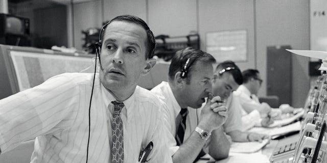 Photo of the archive - Spacecraft communicators are photographed while they keep in touch with Apollo 11 astronauts during their lunar landing mission on July 20, 1969. From left to right astronauts Charles M. Duke Jr., James A. Lovell Jr. and Fred W Haise Jr.