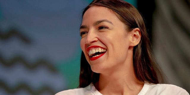 Rep. Alexandria Ocasio-Cortez, D-New York, laughs during South by Southwest on Saturday, March 9, 2019, in Austin, Texas. The festival has grown from obscure roots into a weeklong juggernaut of tech, politics and entertainment. (Nick Wagner/Austin American-Statesman via AP)
