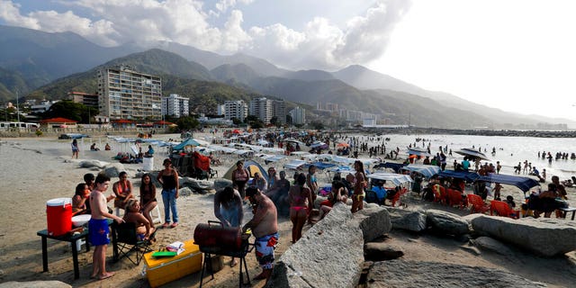 A family from Caracas prepares food during a day trip to Camuri Chico beach in Vargas state, Venezuela, Friday, March 1, 2019. It’s carnival season in Venezuela, though many citizens are not in a mood to party, as the country is gripped by a political crisis that pits leader Nicolas Maduro against Juan Guaido, the opposition chief who was in Paraguay on Friday as part of a campaign to build international pressure on his rival to quit. (AP Photo/Eduardo Verdugo)