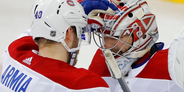 Montreal Canadiens right wing Joel Armia (40) celebrates with goaltender Carey Price (31) after the Canadiens beat the New York Rangers 4-2 in an NHL hockey game, Friday, March 1, 2019, in New York.