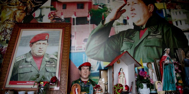 Images of Venezuela's late President Hugo Chavez are surrounded by religious iconography inside a small chapel in the 23 de Enero neighborhood of Caracas, Venezuela, Saturday, March 2, 2019. (AP Photo/Eduardo Verdugo)