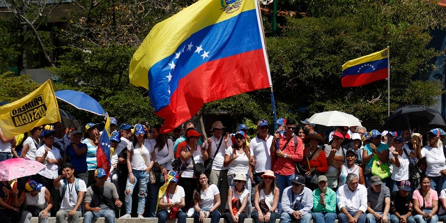 Anti-government protesters start to gather for a rally to demand the resignation of Venezuelan President Nicolas Maduro in Caracas, Venezuela, Monday, March 4, 2019. The United States and about 50 other countries recognize opposition Congress President Juan Guaido as the rightful president of Venezuela, while Maduro says he is the target of a U.S.-backed coup plot. (AP Photo/Eduardo Verdugo)