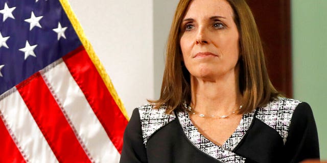 FILE - In this Dec. 18, 2018 file photo, then Rep. Martha McSally, R-Ariz., waits to speak during a news conference at the Capitol in Phoenix. Sen. Martha McSally, R-Ariz., the first female fighter pilot to fly in combat, says she was raped in the Air Force by a superior officer. (AP Photo/Matt York)