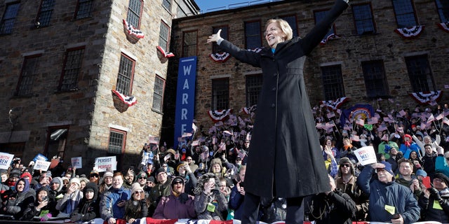 Sen. Elizabeth Warren, D-Mass., acknowledges cheers as she takes the stage during an event to formally launch her presidential campaign in Lawrence, Mass.