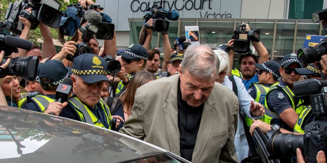 FILE - In this Feb. 26, 2019, file photo, Cardinal George Pell leaves the County Court in Melbourne, Australia. An Australian judge sentenced Wednesday, March 13, the most senior Catholic, Pell, to be convicted of child sex abuse to 6 years in prison for molesting two choirboys in a Melbourne cathedral more than 20 years ago. (AP Photo/Andy Brownbill, File)