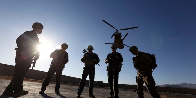 FILE - In this Nov. 30, 2017 file photo, American soldiers wait on the tarmac in Logar province, Afghanistan. Two members were killed Friday during an operation in the country. (Associated Press)