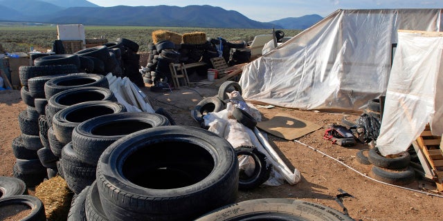 FILE: A makeshift living compound in Amalia, N.M., Aug. 10, 2018. Five former residents of a New Mexico compound where authorities found 11 hungry children and a dead 3-year-old boy are due in federal court on terrorism-related charges.