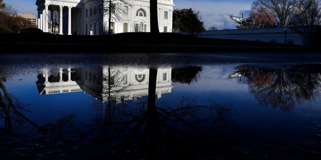A presidential helicopter takes off in a practice run as the White House is reflected in a puddle, Friday March 22, 2019, in Washington, amid news that special counsel Robert Mueller has concluded his investigation into Russian election interference and possible coordination with associates of President Donald Trump. 