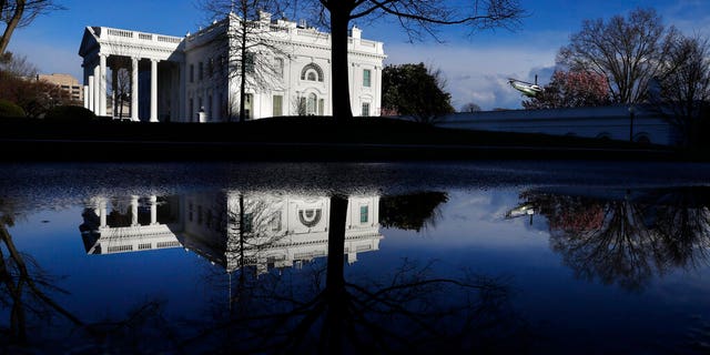 A presidential helicopter takes off in a practice run as the White House is reflected in a puddle, Friday March 22, 2019, in Washington, amid news that special counsel Robert Mueller has concluded his investigation into Russian election interference and possible coordination with associates of President Donald Trump. 